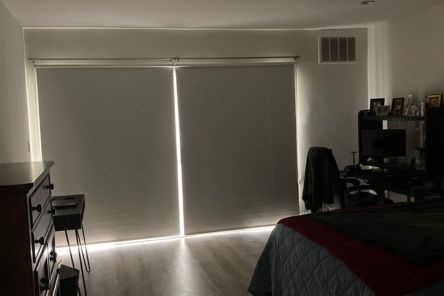 Custom blackout roller shades for windows fully closed on San Francisco bedroom balcony glass door for privacy.